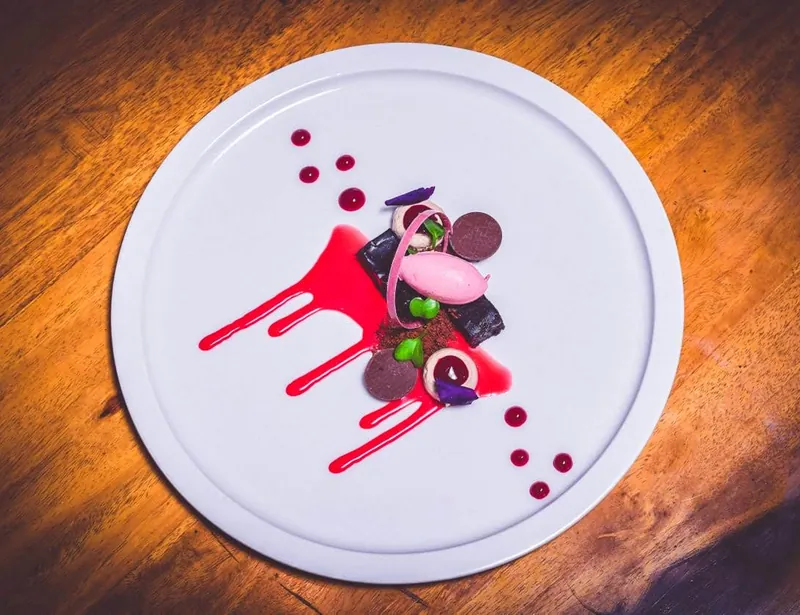 Plated dessert with berry coulis by Gourmet Guys